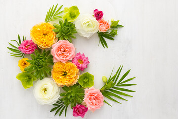 Composition of beautiful flowers, succulents and leaves on light background. Flowers frame.Top view, copy space.