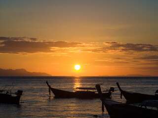 Silhouette sunset light on sea beach with wooden boat colorful sky cloud