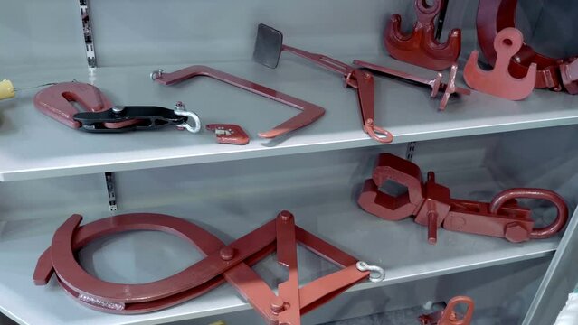 New industrial clamps, grips and holders for holding, lifting and fixing objects while loading, moving and holding. Close up. Shot in motion