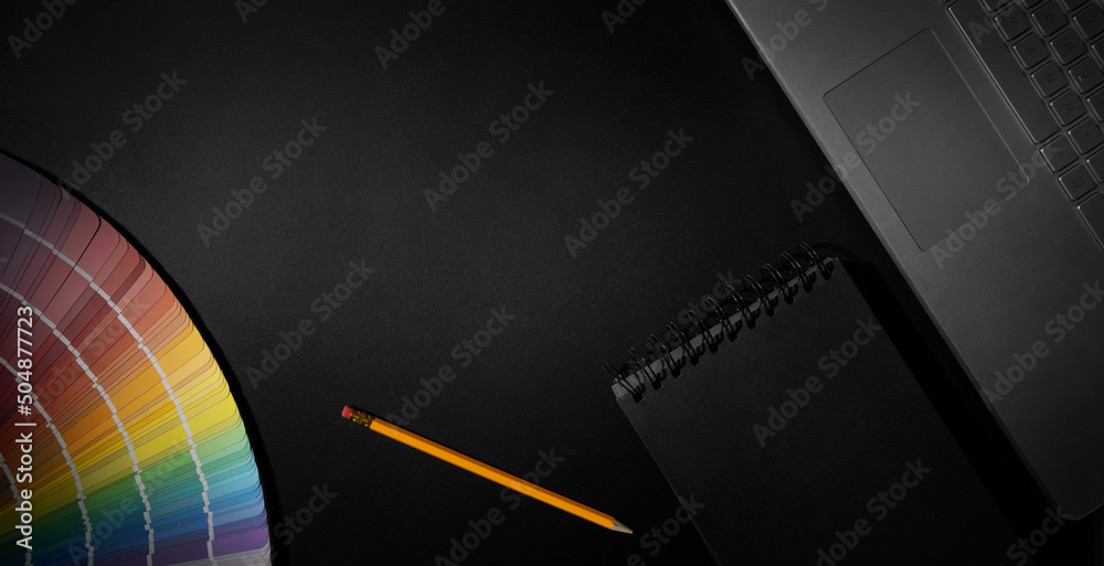 Fototapete designer workspace with laptop, notepad and color swatch on black background. banner with copy space
