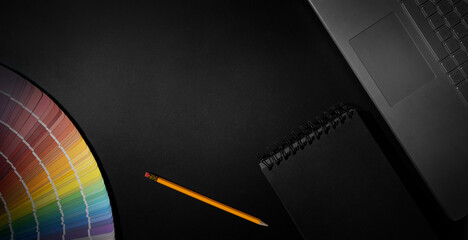 designer workspace with laptop, notepad and color swatch on black background. banner with copy space - obrazy, fototapety, plakaty