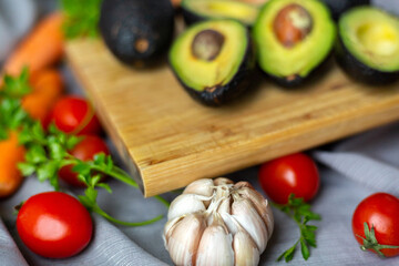 Close up avocado, isolated on white background with several vegetables.