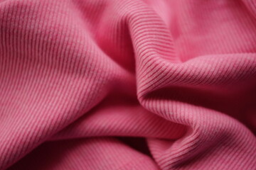 Wrinkled pink micro-ribbed jersey, soft fabric wavy background