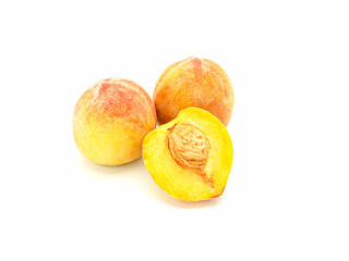 Group of fresh peaches fruit over a white background