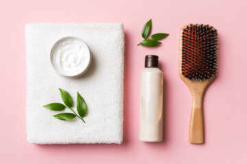 cosmetic for hair care, cream and towel on a colored background top view. flat lay