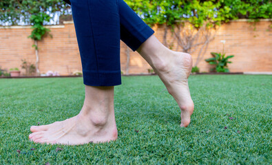 Feet walking on artificial grass.