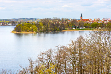 Panoramic aerial view of Jezioro Elckie lake strait with city beach peninsula and wooded shores in Elk town in Masuria region of Poland © Art Media Factory