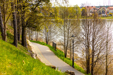 Tourist promenade along Jezioro Elckie lake wooded shore in spring season Elk town of Masuria region in Poland