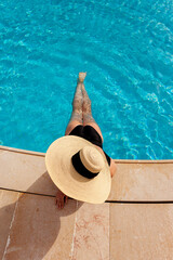 Fototapeta na wymiar Beautiful woman sunbathing by the pool top view horizontal. Summer background. Poster, mock up for design