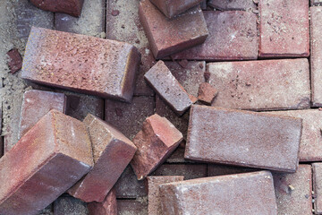 Pink bricks scattered on a newly renovated street. Rubble not yet cleared