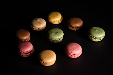 colorful macaroons on black background