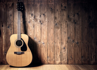 Acoustic guitar against blank wooden plank panel grunge background with copy space - obrazy, fototapety, plakaty