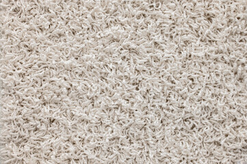 Light shag carpet. Abstract background of shaggy beige fibers.
