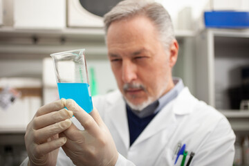 Scientist looking at a test tube