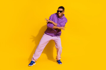 Fototapeta na wymiar Full length body size view of attractive cheerful guy dancing moving rest street isolated over bright yellow color background