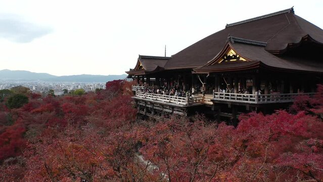 KYOTO, JAPAN - DECEMBER 2021 : View around Kiyomizudera (Kiyomizu Temple) in autumn leaves season. The temple is part of the Historic Monuments of Ancient Kyoto UNESCO World Heritage site.