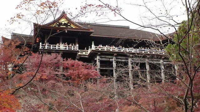 KYOTO, JAPAN - DECEMBER 2021 : View around Kiyomizudera (Kiyomizu Temple) in autumn leaves season. The temple is part of the Historic Monuments of Ancient Kyoto UNESCO World Heritage site.