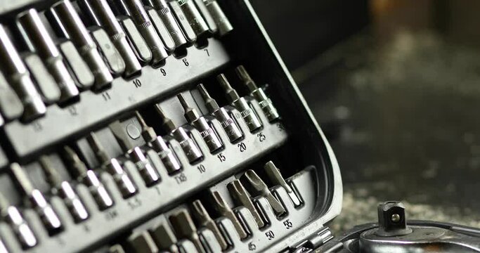 Man hand open set box with working tools different types of metal steel heads and bits at the workshop, Interchangeable screwdriver set.