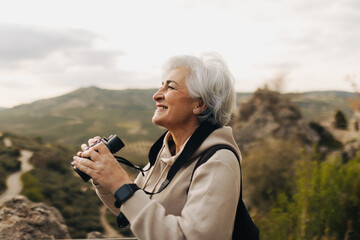 Senior woman looking at the view from a hilltop