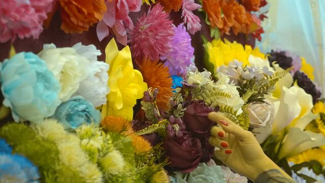 Luxurious wreaths of artificial flowers to decorate the graves at the exhibition. Closeup. Shot in motion