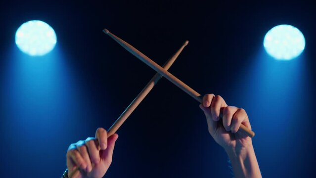Close-up of male hands beating out the rhythm with drumsticks