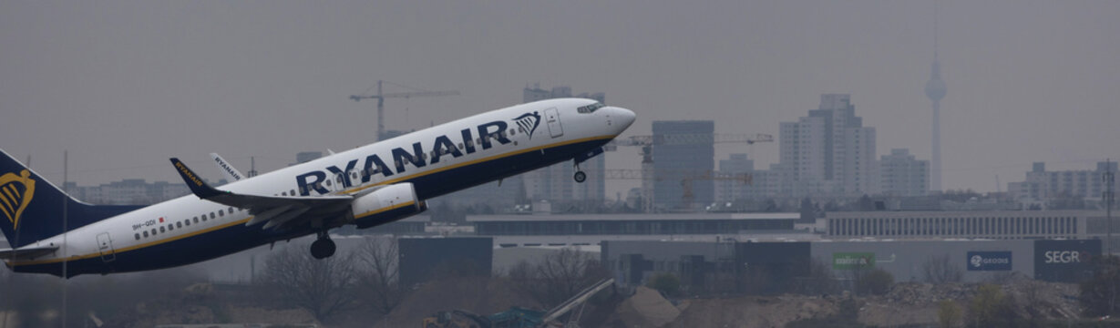berlin,berlin /germany - 24 04 2022: a ryanair airplane over the cityscape of berlin panorama
