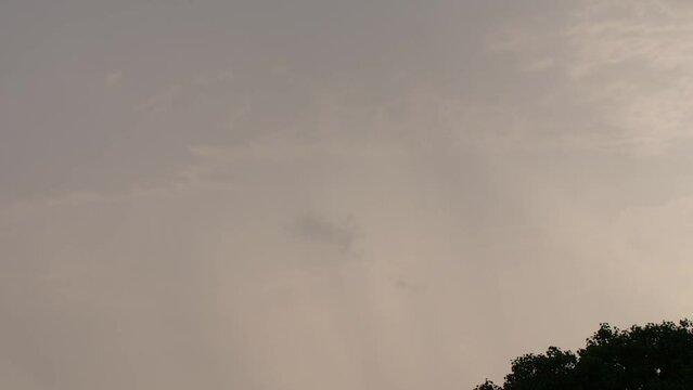 timelaps sunset behind tree cloudes rainy day  India Maharashtra Karnataka south India  rays shine