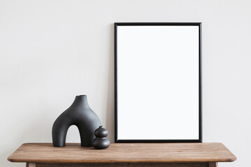 Vertical poster art mockup with black frame and trendy vase on empty wall background, Template for...
