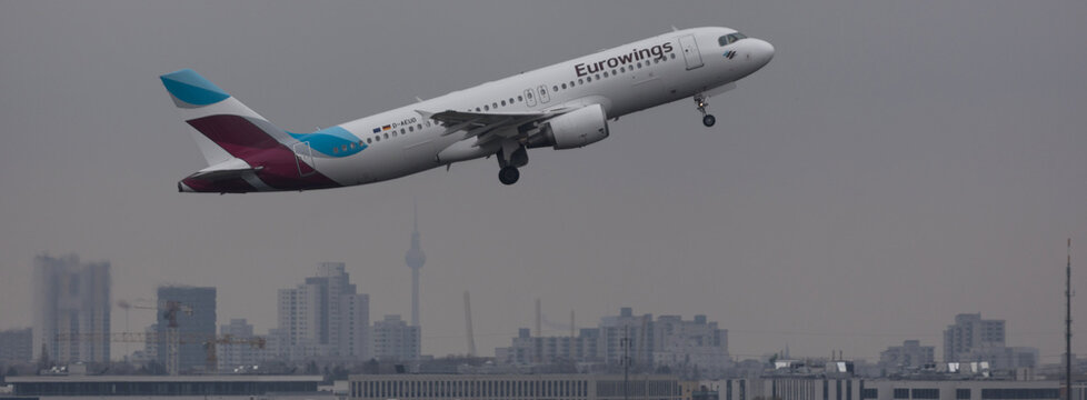 berlin,berlin /germany - 24 04 2022: an eurowings airplane over the cityscape of berlin panorama