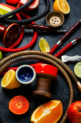 Smoking shisha with citrus fruits.