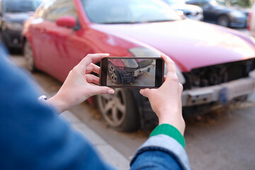Woman insurance broker making photo of car after accident on smartphone - obrazy, fototapety, plakaty