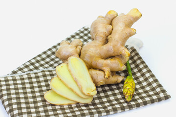 The ginger and ginger flower white background Ginger is an annual plant. With underground rhizomes The outer shell is yellowish brown. The meat in a clay color has a unique fragrance.