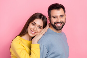 Portrait of attractive cheerful couple bonding spending day time isolated over pink pastel color background