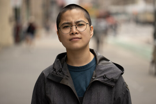 Asian Non-binary Person On A City Street Portrait Seroius