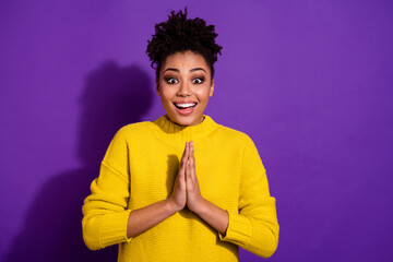 Portrait of excited cheerful girl hands palms pleading look camera isolated on purple color background