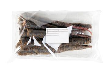 Labeled and packaged purple carrots on an isolated white background