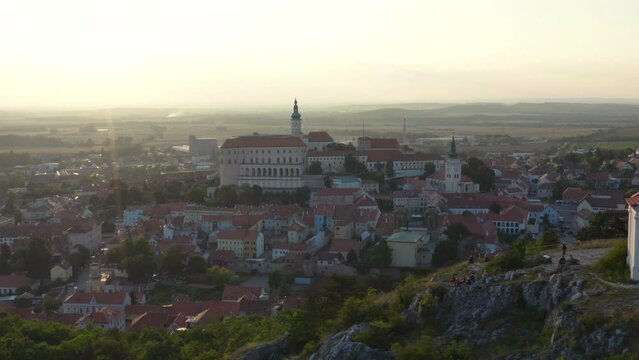 Historic moravian city of Mikulov with castle on hill at sunset, drone.