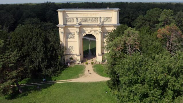 Woman runing under triumphal arch of Diana's temple in Moravia, drone.