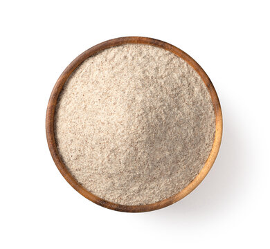Raw rye flour in the wooden bowl, isolated on white background, top view.