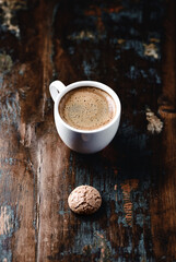 Cup of coffee with Amaretti (Italian biscuits) on rustic wooden background. Copy space.