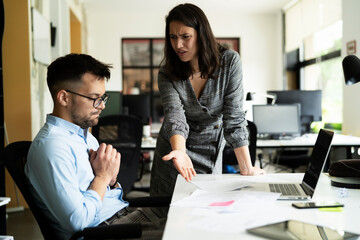 Colleagues arguing in office. Angry businesswoman yelling at her collegue.