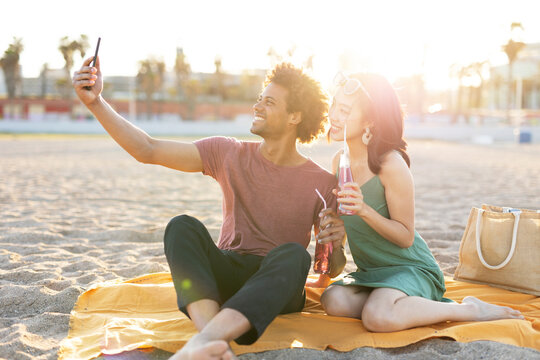 Beautiful young couple enjoy at the beach. Happy couple taking selfie photo