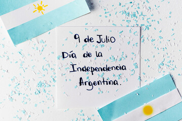 Argentinian flags and writing that says in Spanish July 9 Argentine independence day