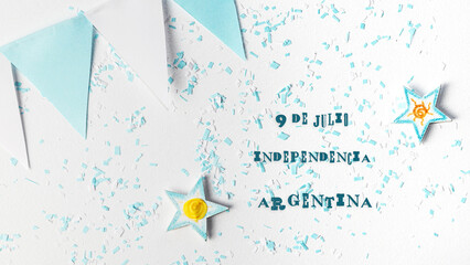 pennants, stars, confetti of the colors of Argentina, written in Spanish July 9 independence of Argentina