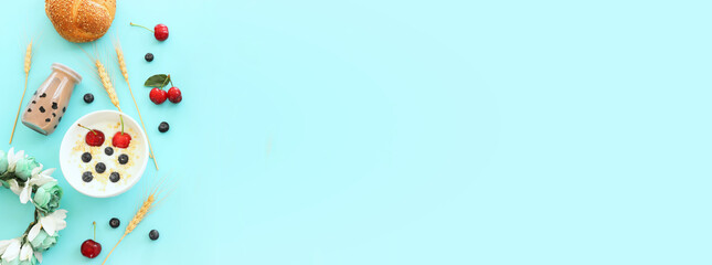 top view photo of dairy products and fruits over pastel blue background. Symbols of jewish holiday - Shavuot