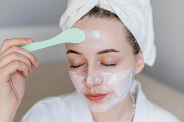The girl is engaged in a beauty procedure at home. Time for yourself. Taking care of yourself. Girl makes a face mask at home. Skin care at home. Teen skin care.