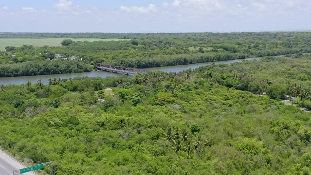 Flying Towards The Ancient Bridge Over Soco River In San Pedro de Macor&iacute;s, Dominican Republic. Aerial Drone Shot