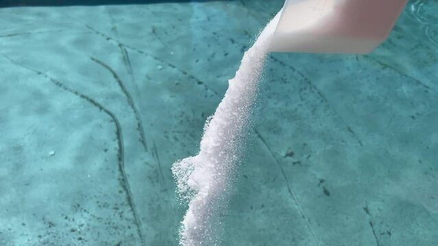Adding chemicals and pool salt into dirty pool after opening