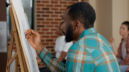 Portrait of african american student drawing contemporary sketch at art workshop lesson. Creative...