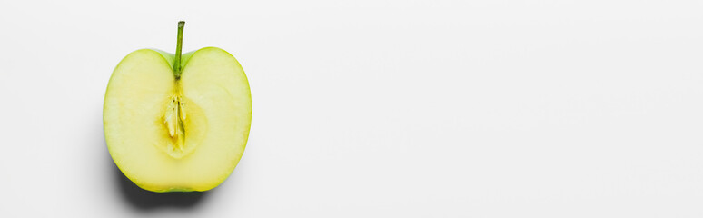 Top view of cut fresh apple on white background, banner.